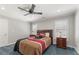 Comfortable bedroom featuring a ceiling fan, a dresser, and plantation shutters at 1414 Lynchburg Trce, Grayson, GA 30017