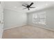 Spacious bedroom with neutral carpet, plantation shutters, ceiling fan, and a walk-in closet at 1414 Lynchburg Trce, Grayson, GA 30017