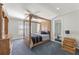 Bedroom with four-poster bed, ceiling fan, dresser, and ensuite bathroom with glass shower at 1414 Lynchburg Trce, Grayson, GA 30017