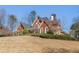 Lovely brick home on a lush green lawn featuring mature trees at 1414 Lynchburg Trce, Grayson, GA 30017