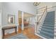 Open foyer featuring hardwood floors, staircase, and a view into the dining room at 1414 Lynchburg Trce, Grayson, GA 30017