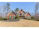 Beautiful brick home with lush landscaping and manicured lawn on a sunny day at 1414 Lynchburg Trce, Grayson, GA 30017