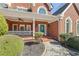 Inviting brick front porch with rocking chairs and a well-manicured landscape at 1414 Lynchburg Trce, Grayson, GA 30017