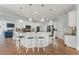Bright kitchen with white cabinets, a large island with seating, and granite countertops at 1414 Lynchburg Trce, Grayson, GA 30017