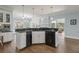 Open kitchen with a breakfast bar, black appliances and hardwood floors at 1414 Lynchburg Trce, Grayson, GA 30017