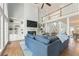 Cozy living room featuring built-in bookshelves, a fireplace, and large windows at 1414 Lynchburg Trce, Grayson, GA 30017