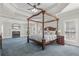 Spacious primary bedroom featuring a four-poster bed, fireplace, and large windows at 1414 Lynchburg Trce, Grayson, GA 30017