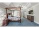 Generous main bedroom with trey ceiling, dark wood accents and blue carpet at 1414 Lynchburg Trce, Grayson, GA 30017