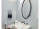 A half-bath with a decorative mirror and a stylish sink and faucet at 1414 Lynchburg Trce, Grayson, GA 30017
