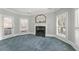 Sitting room with a cozy fireplace, natural light, and plantation shutters at 1414 Lynchburg Trce, Grayson, GA 30017