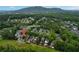 Aerial view of a neighborhood surrounded by dense trees with a mountain backdrop at 1456 Hedgewood Nw Ln, Kennesaw, GA 30152