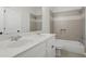 Bathroom featuring dual sinks, large mirror, white cabinets and tiled shower/bath at 1456 Hedgewood Nw Ln, Kennesaw, GA 30152