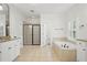Primary bathroom boasts soaking tub, tile floors, walk-in shower and dual sink granite vanity at 1456 Hedgewood Nw Ln, Kennesaw, GA 30152
