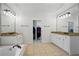 The primary bathroom features double sinks, granite countertops, vanity space and separate soaking tub at 1456 Hedgewood Nw Ln, Kennesaw, GA 30152