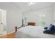 A cozy bedroom with a comfortable bed, natural light, and hardwood floors at 1456 Hedgewood Nw Ln, Kennesaw, GA 30152