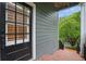 Stylish black front door with sidelight on a gray home with a landscaped entry at 1456 Hedgewood Nw Ln, Kennesaw, GA 30152