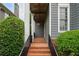 Charming front porch features brick steps, iron railings, and mature landscaping at 1456 Hedgewood Nw Ln, Kennesaw, GA 30152