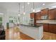 A stylish kitchen features stainless steel appliances, custom cabinets, a central island, and hardwood floors at 1456 Hedgewood Nw Ln, Kennesaw, GA 30152