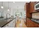 Open-concept kitchen with stainless appliances, hardwood floors, and adjacent breakfast area with bright natural light at 1456 Hedgewood Nw Ln, Kennesaw, GA 30152