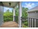 Covered porch with black railing offers serene views of lush greenery at 1456 Hedgewood Nw Ln, Kennesaw, GA 30152