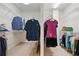 Custom designed dual walk-in closet with shelving and ample storage space for clothes and accessories at 1456 Hedgewood Nw Ln, Kennesaw, GA 30152
