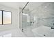Bright bathroom features a soaking tub, walk-in shower, and marble-style walls creating a spa-like and relaxing environment at 155 Westbrook St, Buford, GA 30518