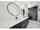 Modern bathroom with double sinks, a marble countertop, and a luxurious glass-enclosed shower at 155 Westbrook St, Buford, GA 30518