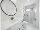 Stylish bathroom with a marble shower and an oval mirror over a modern vanity at 155 Westbrook St, Buford, GA 30518