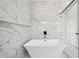 Elegant bathroom features a soaking tub, marble tile walls, and a glass-enclosed shower, creating a tranquil retreat at 155 Westbrook St, Buford, GA 30518