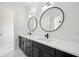 Elegant bathroom featuring dual sinks, a white countertop, dark cabinetry, and modern fixtures at 155 Westbrook St, Buford, GA 30518
