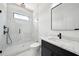 Modern bathroom features a glass enclosed shower with black fixtures, and a vanity with black cabinets at 155 Westbrook St, Buford, GA 30518