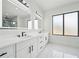 Sleek bathroom features double vanity, marble floors, large windows and modern fixtures, creating a luxurious and relaxing space at 155 Westbrook St, Buford, GA 30518