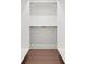 Empty closet with two metal rods for hanging clothes and wood floor, ready for storage at 155 Westbrook St, Buford, GA 30518