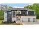 New construction two-story home with a brick exterior, a two-car garage, and dark trim at 155 Westbrook St, Buford, GA 30518