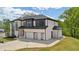 Side view of new construction two-story home featuring a two-car garage and modern design at 155 Westbrook St, Buford, GA 30518