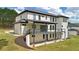 Side view of a modern two-story home with white brick, black trim, and a deck overlooking the yard at 155 Westbrook St, Buford, GA 30518