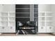 A modern living room fireplace with an electric firebox, custom marble surround and white built-in shelves at 155 Westbrook St, Buford, GA 30518