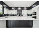 Spacious kitchen boasts a large island with marble countertops, custom cabinets and stainless steel appliances at 155 Westbrook St, Buford, GA 30518