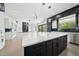 Open-concept kitchen with a large island featuring seating, blending into a spacious living area at 155 Westbrook St, Buford, GA 30518