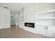 Bright living room featuring an electric fireplace, custom shelving, and light hardwood floors at 155 Westbrook St, Buford, GA 30518