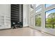 Sunlit living room boasting hardwood floors, a fireplace, and large windows with picturesque views at 155 Westbrook St, Buford, GA 30518