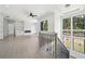 Open living room with recessed lighting, a fireplace, a ceiling fan, and large windows at 155 Westbrook St, Buford, GA 30518
