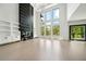 Open living area with a modern fireplace, white built-ins, hardwood floors, and natural light at 155 Westbrook St, Buford, GA 30518