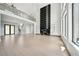 Spacious living area featuring a modern fireplace, second-floor balcony, and an abundance of natural light at 155 Westbrook St, Buford, GA 30518