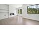 Bright living room with built-ins and a modern fireplace, showcasing large windows and ample light at 155 Westbrook St, Buford, GA 30518