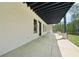Covered patio featuring concrete flooring, white brick, dark trim, and an outdoor living space at 155 Westbrook St, Buford, GA 30518