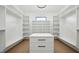 Walk-in closet with built-in shelving and a central island for organized storage at 155 Westbrook St, Buford, GA 30518