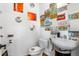 Small bathroom with eclectic decor features license plate art, pedestal sink, and toilet, creating a compact and unique space at 230 Bradberry Sw St # 9, Atlanta, GA 30313