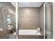 Bathroom features a modern soaking tub with glass shower, grey tiling, and contemporary fixtures creating a serene spa-like retreat at 230 Bradberry Sw St # 9, Atlanta, GA 30313