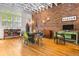 Open dining area with exposed brick wall, hardwood floors, and abundant natural light at 230 Bradberry Sw St # 9, Atlanta, GA 30313